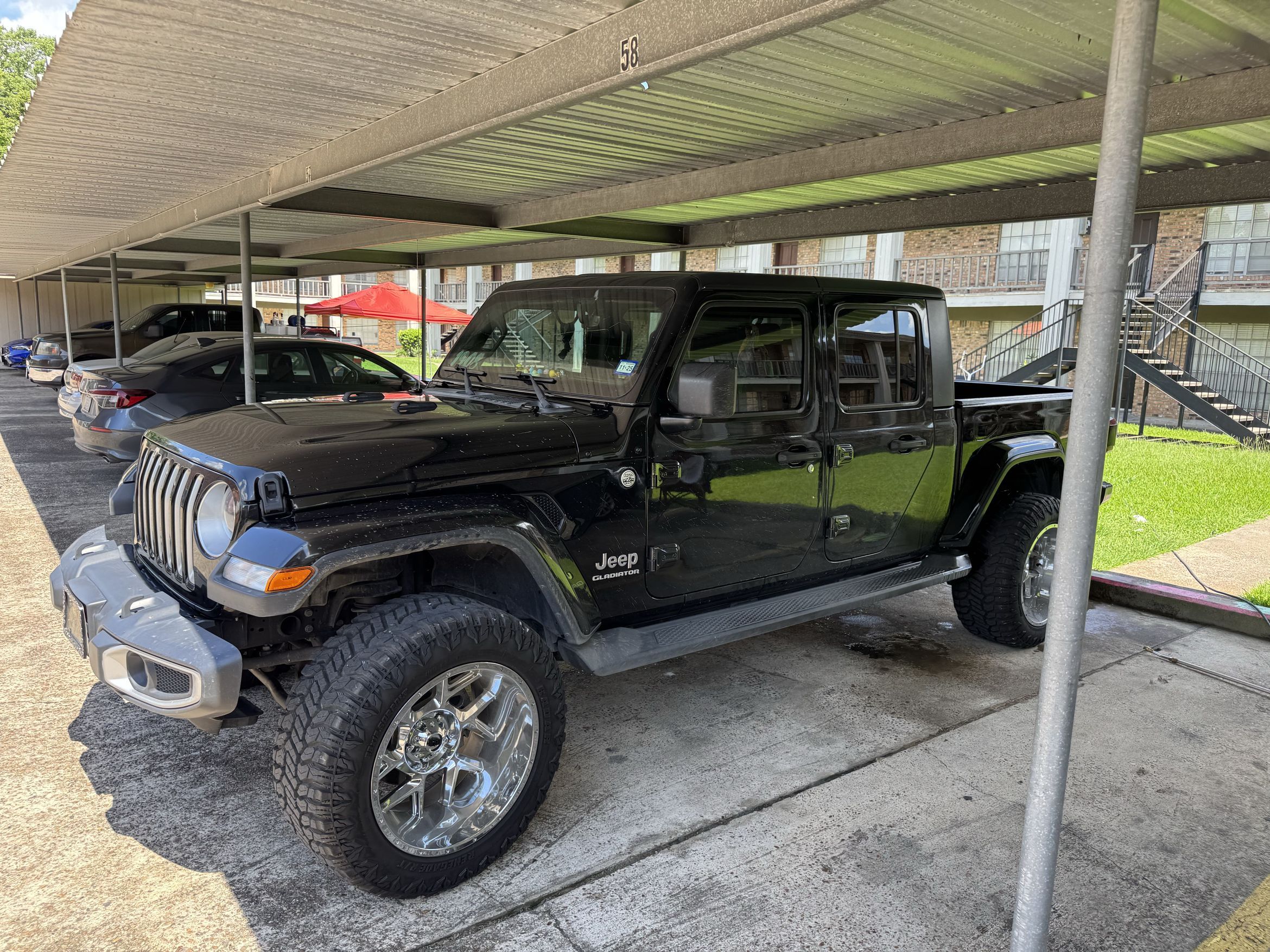 Black Jeep Gladiator parked after a full detail